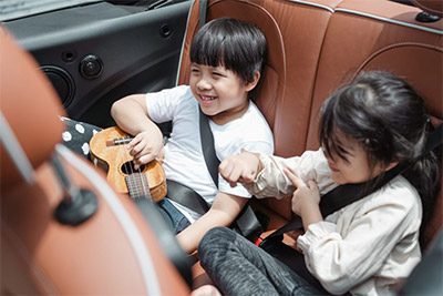 Kids in car using a seat belt guard