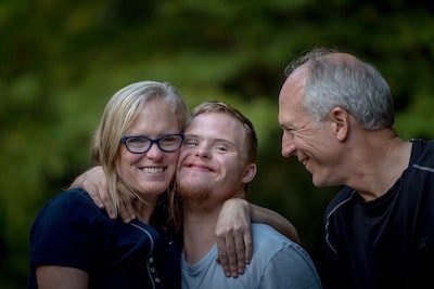 family with child who has disability happy after using seat belt guards