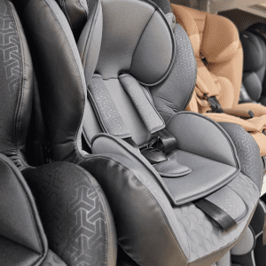 A close-up image of a modern child's car seat featuring a stylish gray design with intricate patterns.